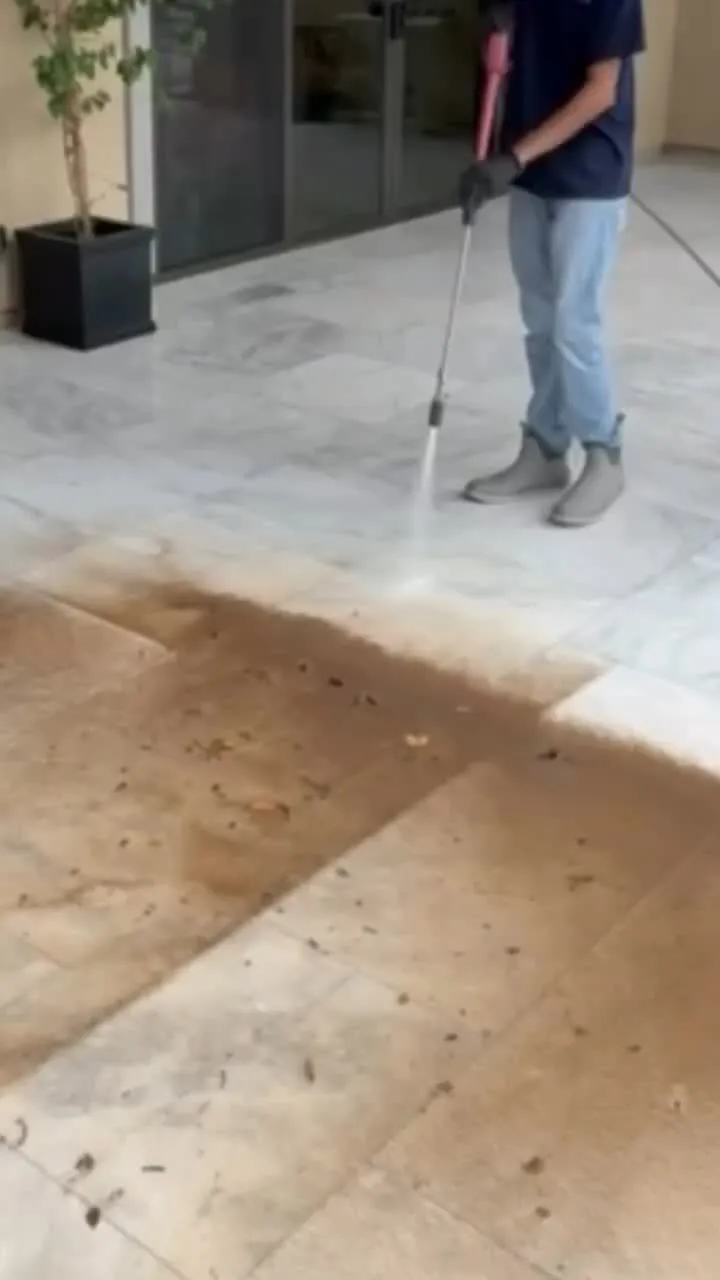 Half-cleaned travertine patio showing the contrast between washed and unwashed stone