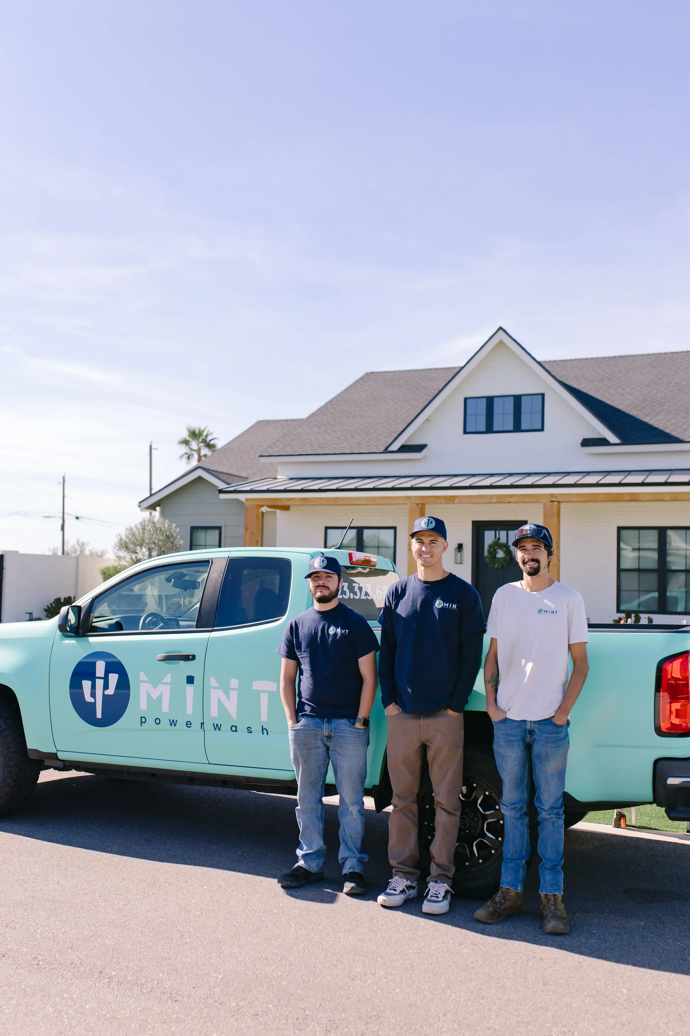 Three MiNT crew members standing in front of a mint truck